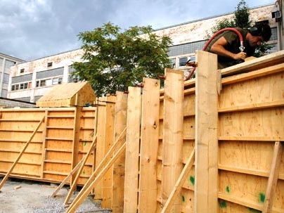 Graduate student Joe Dahmen works inside the wooden cavity used during the wall's construction.