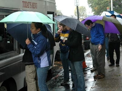 For a queue of hungry customers, determination to get a warm meal from a lunch truck near campus outweighs the inconveniences of waiting in the rain.