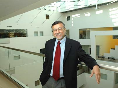Mriganka Sur, head of the Department of Brain and Cognitive Sciences, stands on a balcony overlooking the 90-foot atrium inside the new Brain and Cognitive Sciences Complex, which will be officially dedicated on Friday, Dec. 2.