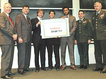 Team Radiant Flux accepts its award for winning the Soldier Design Competition at MIT on Wednesday, March 1. Team members holding the certificate are, from left, Justin Holland, Gary Long and Chandan Das. They are flanked by Institute for Soldier Nanotechnologies (ISN) Director Ned Thomas, far left, standing next to MIT competition coordinator Kurt Keville and Gen. Benjamin Griffin far right, stan...