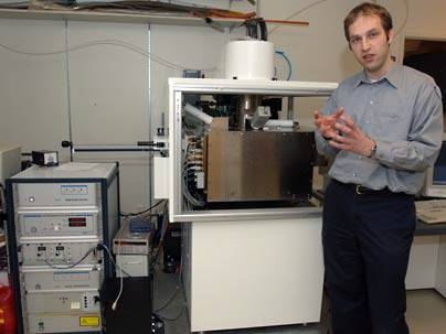 Assistant Professor Karl Berggren used the machine behind him to make nanowires, new technology that may speed interplanetary communications.
