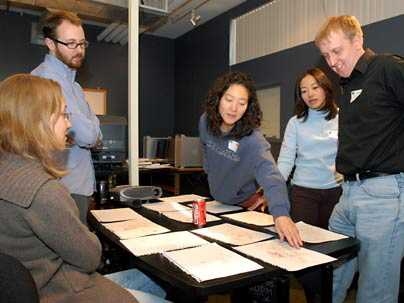 MBA students from the MIT Sloan School of Management work on a cartoon storyboard at the School of the Museum of Fine Arts on Tuesday, March 21, during Sloan Innovation Period. Pictured, from left, are Kielo Ahomaa, Tom Marquet (a Museum School student), Eun-Joung Lee, Lilly Zhu and Corey Halverson.