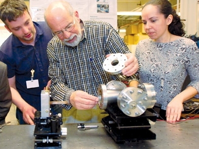 Professor John Kassakian examines a thermophotovoltaic device late last month with, from left, doctoral students Ivan Celanovic and Natalija Jovanovic.