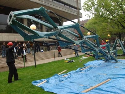 The winning mini-skyscraper 'Muscles' is hoisted into position in front of the Student Center on Friday, May 12.