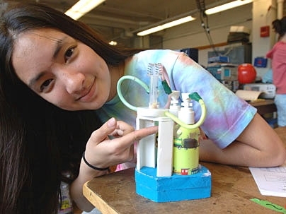 Freshman Karlen Ruleman shows her team's dental-hygiene creation, 'Flava-Rama,' which lets children mix toothpastes.