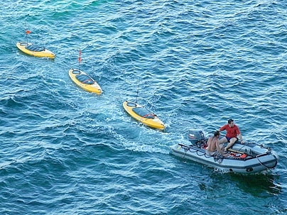 MIT research engineer Joseph Curcio and mechanical engineering graduate student Robert R. Williams tow three SCOUTs after an outing in the waters off Pianosa, Italy, last July.