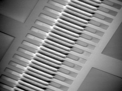 This micropump developed by MIT researchers allows high speed flows through microchannels with an input of only a few volts of electricity, making it possible to create portable "lab on a chip" devices.
The three-dimensional, alternating current electro-osmotic pump consists of interdigitated stepped gold microelectrodes on a glass substrate.