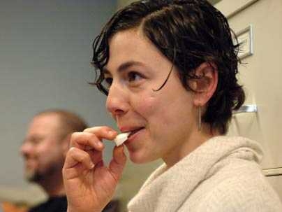 Anya Zilberstein, graduate student in MIT's Science, Technology and Society program, tries an artisanal cheese sample discussed and served by anthropology professor Heather Paxson on Dec. 11.