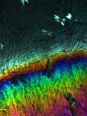 MIT engineers have produced a new strong, stretchy nanocomposite material. This micrograph shows the results of tensile stretching: The un-stretched region (above grip line) exhibits bright domains, indicating order and alignment of the polyurethane and nano-clay. Upon stretching, the dark, disorganized polymer chains become aligned and brighten in color due to polymer alignment, while the bright ...