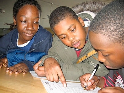 STEM students Terrain Edwards-Grant, Darren Chanel-Volmar and Jamie Edwards support one another's success.