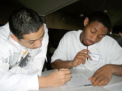 Colin Smith, left, digs into homework with his STEM mentor, Clinton Scroggins.