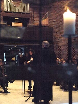 Jean Rife, a lecturer in music and theatre arts at MIT, lit a candle for one of the victims of the shootings at Virginia Tech at an interfaith service at the MIT Chapel on Wednesday.