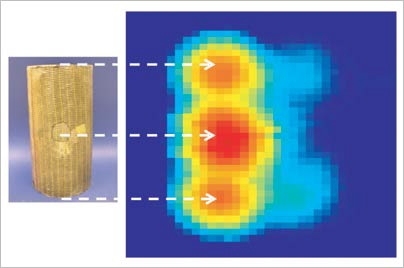 An area of the fiberglass-wrapped concrete cylinder on the left has damage underneath the wrapping that is not apparent to the naked eye, but can be seen in the computer visualization at right, as revealed by data from a new radar detection system. Red indicates damage.
