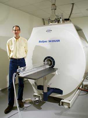 Steven Shannon, operations manager and MR research technologist at MIT, with the 9.4 Tesla MRI machine in the Martinos Imaging Center at the McGovern Institute.