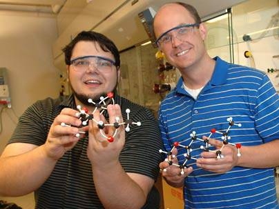 MIT Professor Tim Jamison, right, and co-author Ivan Vilotijevic, a grad student in chemistry, have discovered how the organisms behind red tide may produce the algal bloom's toxic effects. They hold models of molecules that, in water,Â transform into representative portions of the red tide toxins.