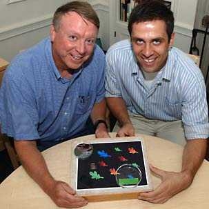 Ned Thomas, Morris Cohen Professor of Materials Science and Engineering and head of the department, left, and Joseph Walish, graduate student in materials science and engineering, display a new structured gel that can rapidly change color in response to a variety of stimuli.