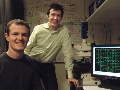 From left, graduate student Joseph Kovac and Joel Voldman, associate professor of electrical engineering and computer science, have developed an inexpensive and easy method for sorting cells for microscope examination, using microfluidics and a laser beam "firehose."