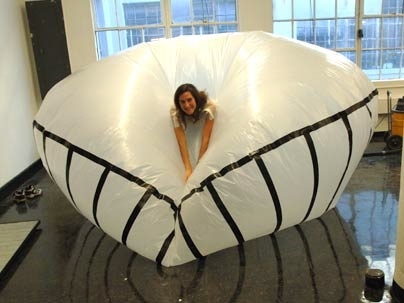 Graduate student Mary Hale floats around in her Monumental Helium Inflatable Wearable Floating Body Mass, a means of mental escape and personal ease.