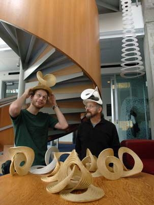 Erik Demaine, left, the Esther and Harold Edgerton Associate Professor of Electrical Engineering, and his father, CSAIL visiting scientist Martin Demaine, model a couple of their sculptures in a Museum of Modern Art show titled 'Design and the Elastic Mind,' which runs until early May.