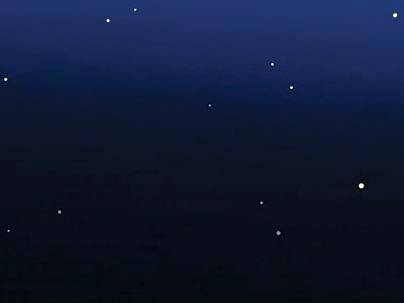 The stars' light is obscured, except for a faint reflection from the disk's far side.