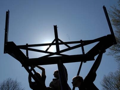 MIT students hoist the base of their concentrating solar power system.