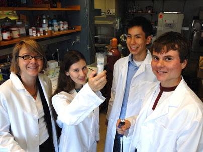 Professor Linda Griffith admires the way that Course 20 graduating seniors Lissa Riley, Mike Yee, and and Andrzej Wojcieszynski meld their knowledge of thermodynamics and laboratory savvy to derive festive experiments in celebration of the first graduating class of biological engineers.