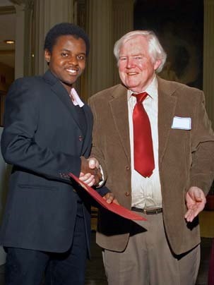 Civil engineering graduate student Sanusi Dantata from Kano, Nigeria, accepts the Tucker-Voss Award for promise in the field of building construction from Professor Jerome Connor.