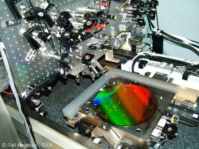 Gratings used to manipulate X-rays for future space telescopes and other applications,Â like tiny miniaturized venetian blinds,Â were created using this interference lithography patterning tool, called the nanoruler, developed at MIT's Space Nanotechnology Laboratory. The colorful, diffracting wafer at center has a diameter of 12 inches.