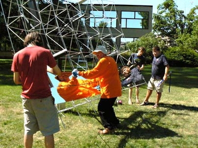 Matt Ritter, Doug Wood, Spencer Ahrens and Micah Sze mount one of the 10-inch by 12-foot mirror panels in place.