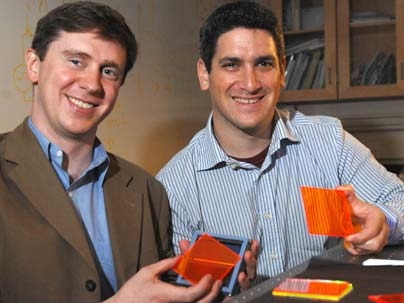Marc Baldo, associate professor of electrical engineering and computer science (left) and Shalom Goffri, postdoc in MIT's Research Laboratory of Electronics (right) hold examples of organic solar concentrators.