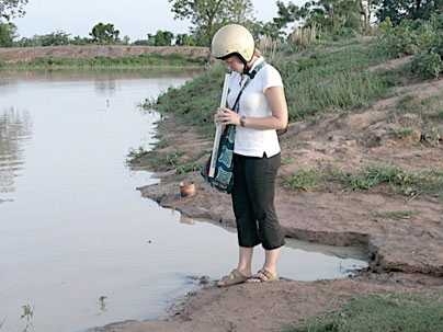 Graduate student Kate Clopeck checks the turbidity of water of the Kakpagayelli dugout in Ghana.