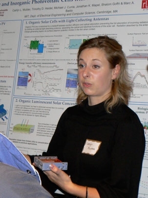 Carlijn Mulder, a graduate student in electrical engineering, demonstrates a new kind of concentrating solar cell being developed by MIT researchers.