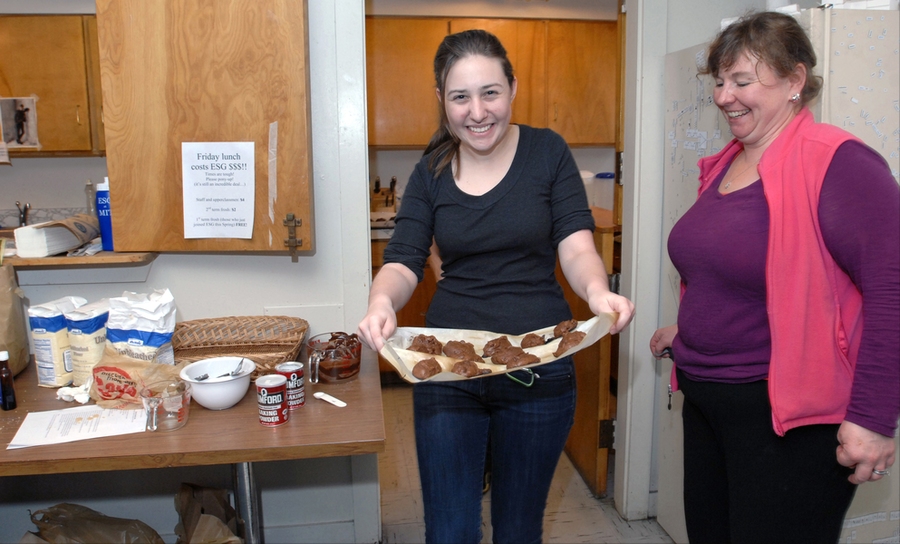 Freshman Betsy Flowers comes out of ESG kitchen with her 'Death by Chocolate' chocolate chip cookies as instructor Patti Christie looks on.