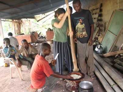 Ela Ben-Ur '97, SM '99, one of the International Development Design Summit organizers, pounds a mixture of plants to make a porridge called fufu, a local staple food, at a small farm in Ghana.
