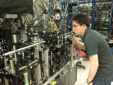 Graduate student Gyu-boong Jo optimizes the laser beam position on the mirror of the optical setup that produced an ultracold gas of lithium atoms.