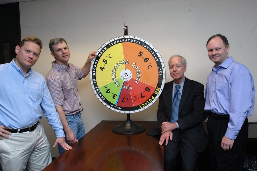 Ronald Prinn, director of MIT's Center for Global Change Science, and his group have revised their model that shows how much hotter the Earth's climate will get in this century without substantial policy change. Standing with the group's "roulette wheel" are, from left to right, Mort Webster, professor in the Engineering Systems Division; Adam Schlosser, principal research scientist at the Center ...