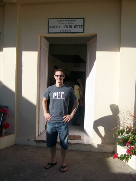 Chris Moses stands in front of the Municipal Health Office in Batanes, Philippines.