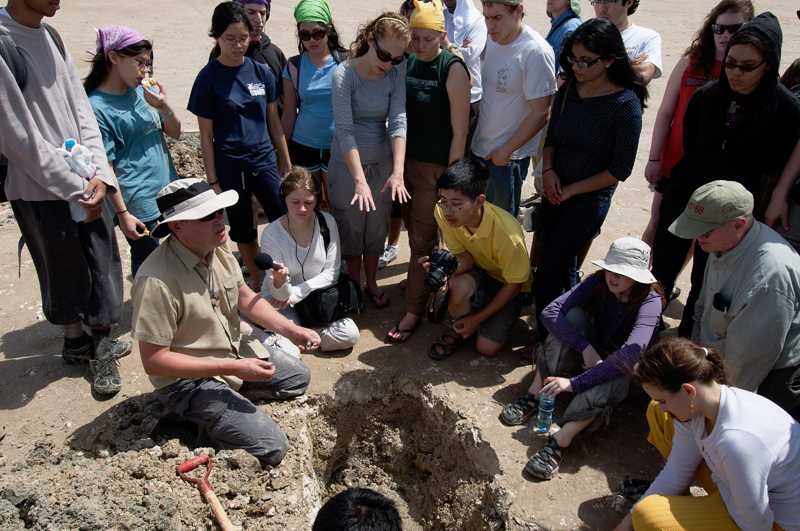 During the trip, the group visited a coastal sabkha, which is a flat, salt-encrusted desert that may sit atop oil and gas reserves. Here, Stephen Lokier, a professor at the Petroleum Institute in Abu Dhabi, explains the composition of each layer of the sediment, which is a mixture of carbonate sands, muds and minerals.