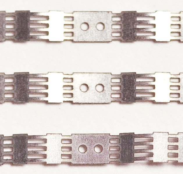 Rectangular notches carved into the shape-memory alloy increase its electrical resistance, so that only the material around the notches heats up when an electrical current passes through the actuator. The round holes are for bolts that attach the actuator to a mechanical device. 