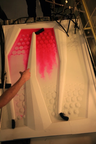 Because certain plants absorb toxins, wetlands with copious vegetation can clean up pollution. However, the water flowing through wetlands must move in a slow, evenly-dispersed pattern, to ensure maximum contact with the plants. Here the researchers inject fluorescent dye into the water to analyze its flow pattern. 