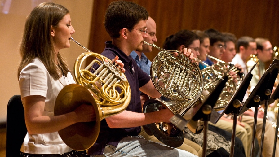 The French horn section (Vanessa Gardner, Peter James, Jared Krueger and others) responds to Dudamel's direction.