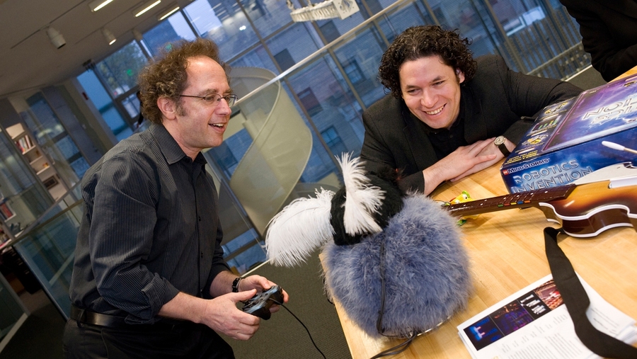 Dudamel with Professor of Music and Media Tod Machover, demonstrating a robot and musical software created in the Media Lab.