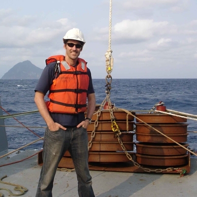 Thomas Peacock, an associate professor of mechanical engineering, on the deck of a research ship during a recent trip to study internal waves in the ocean.