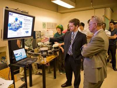 Phillip Cunio, an AeroAstro doctoral student, explains the TALARIS (Terrestrial Artificial Lunar and Reduced Gravity Simulator) project to Bolden. The MIT student project is aimed at designing, building and operating a prototype test vehicle for robotic lunar landers as part of MIT's participation in the Google Lunar X-Prize.