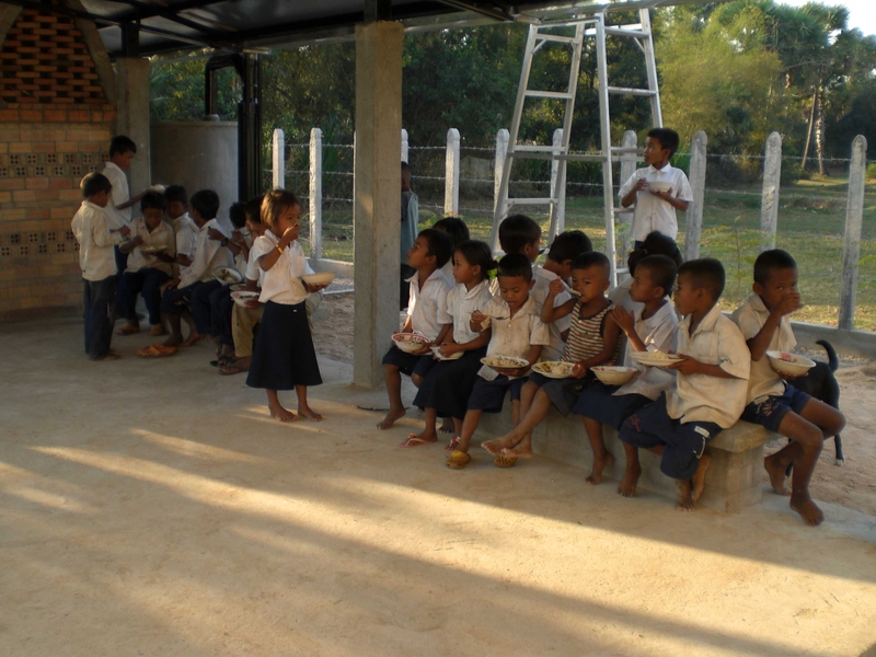 Children at the Ampil Peam school eating in the newly built kitchen and dining pavilion. 