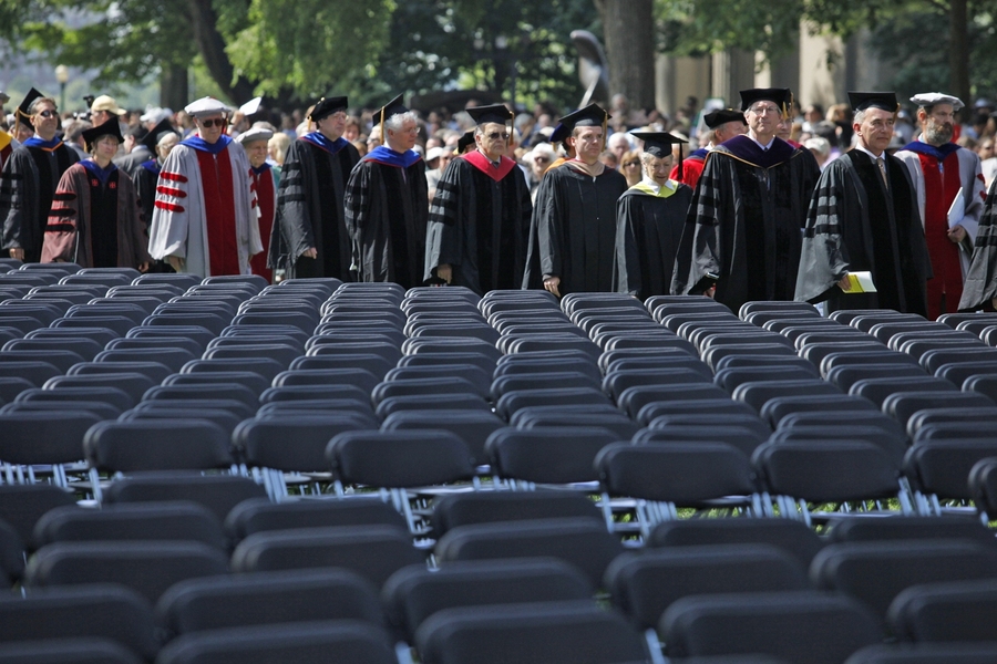 The procession makes its way through the graduate seating area toward the main stage in Killian Court.