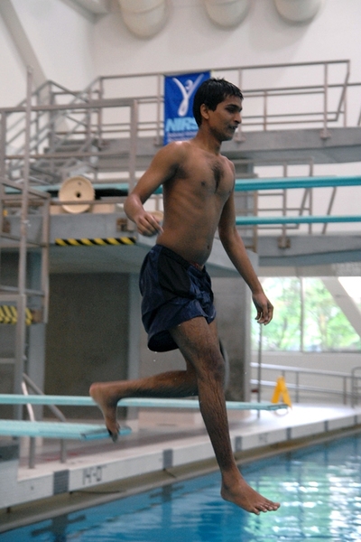 Srikanth Bolla ’13 jumps off the diving board for the first time in the MIT Beginner's Swim class. 