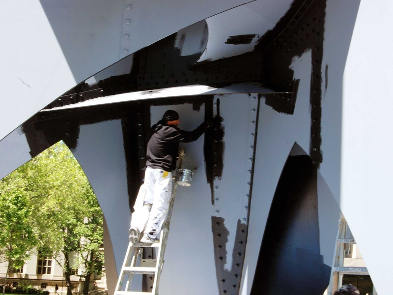 Here, workers finish painting the 33-ton sculpture, which was installed in 1966.  