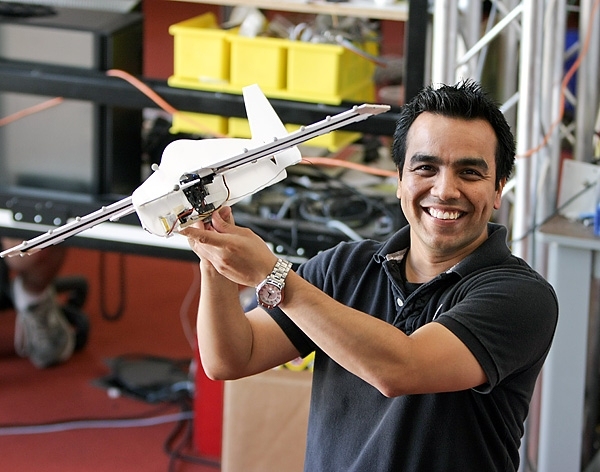 Postdoctoral Associate Rick Cory poses with the perching glider he helped develop.