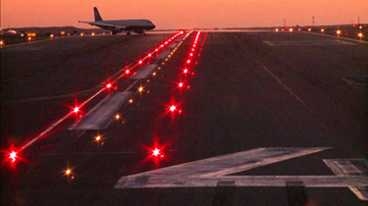Takeoff Hold Lights are shown implemented at the Los Angeles International Airport. These components of the Runway Status Lights system are placed at departure positions and indicate to pilots that it is unsafe to take off because a runway ahead is occupied by another aircraft.